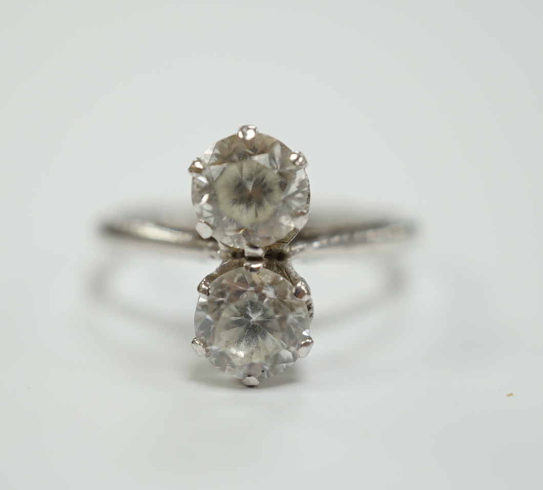 A mid 20th century white metal (stamped plat) and two stone white zircon? set ring, size M, gross weight 4.9 grams.